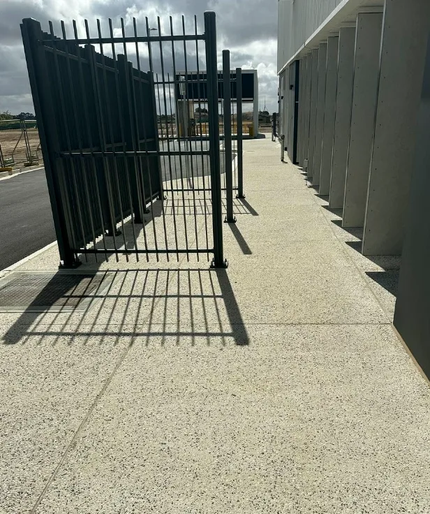Long concrete pathway running alongside a building