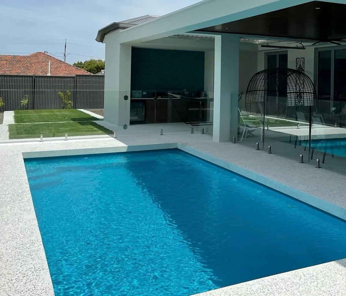 Concrete pool surrounds and alfresco beside a swimming pool