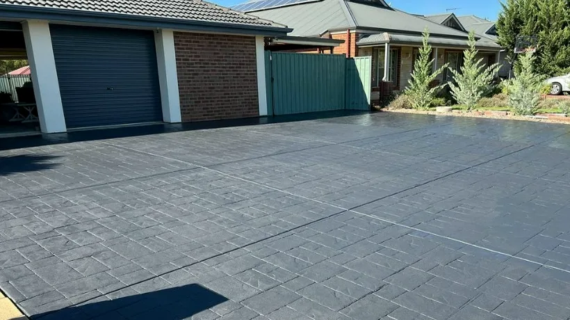 Stamped and patterned concrete driveway in front of a garage