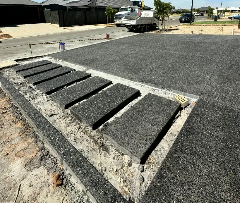 Charcoal exposed aggregate with inset concrete steppers